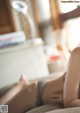 A woman laying on a couch with her legs crossed.